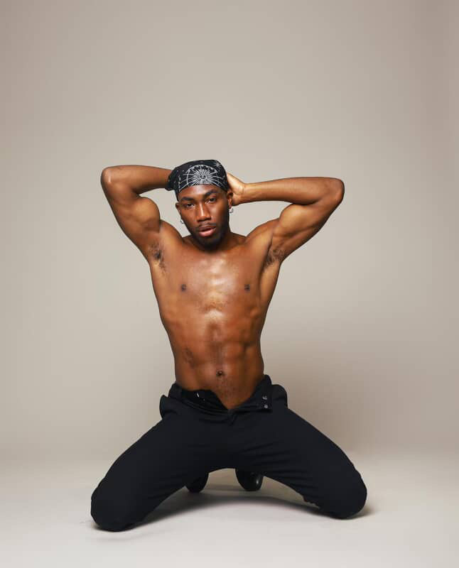 SEAF 2026 Performers: What Unfolds On and Off the Stage Pole performer Halo posing in a kneeling pose with hands on head